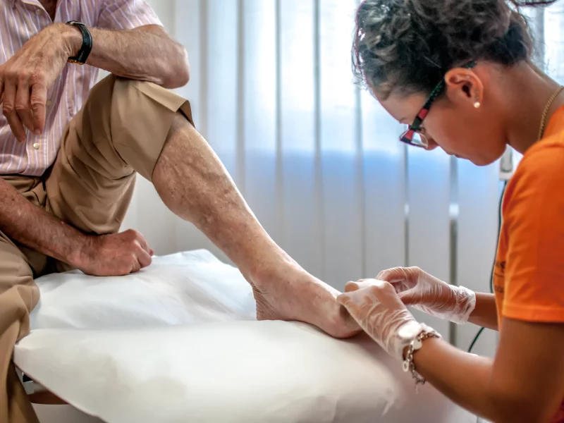A podiatrist treating a patient’s foot