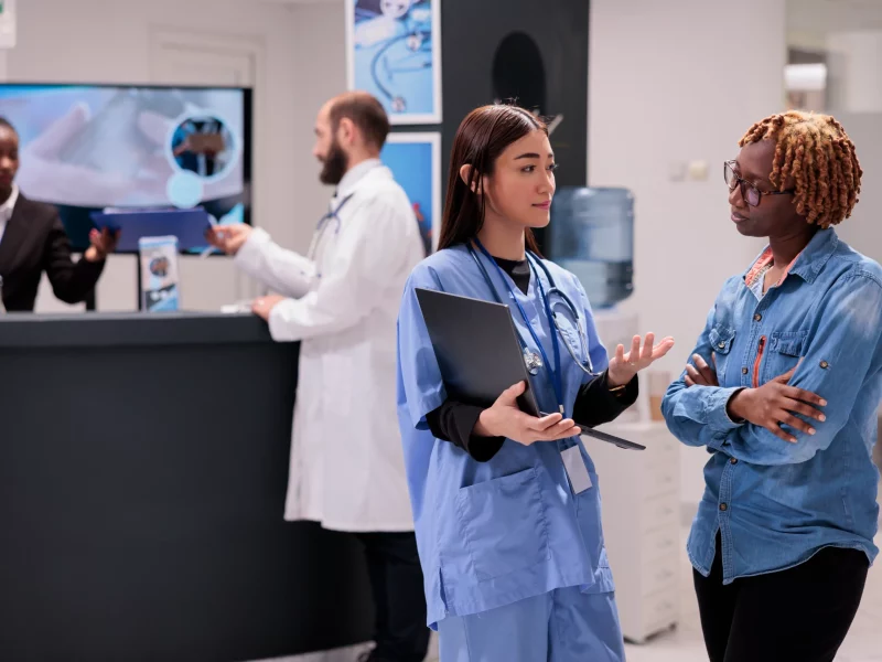 A nurse showing a healthcare diagnosis to a patient